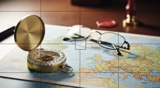 A professional editorial photograph depicting a symbolic representation of UK digital services VAT compliance after Brexit, featuring a vintage brass compass resting on layered maps of Europe and the United Kingdom.